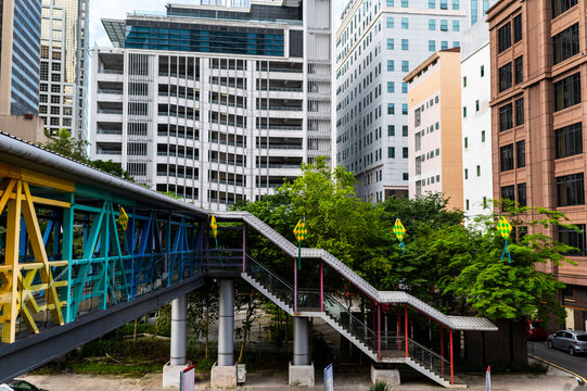 Elevated pedestrian bridge connecting dense contemporary cityscape