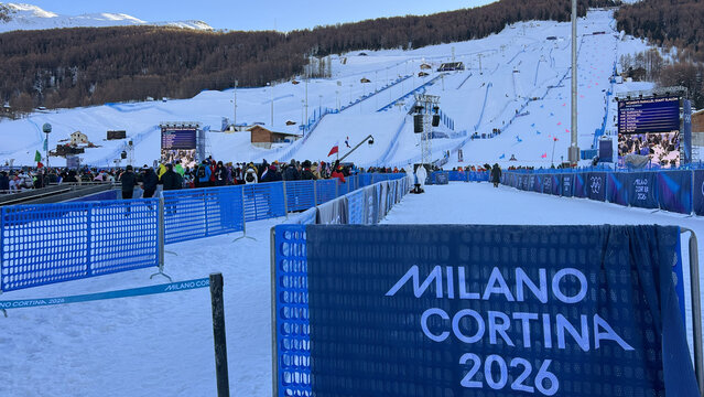 Livigno, Italy &ndash; February 8, 2026: Milano Cortina 2026 signage and crowd at the alpine ski venue during the Winter Olympic Games in Livigno
