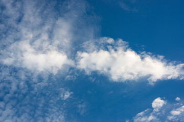 Bright Blue Sky with Soft White Clouds