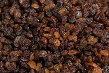 Fototapeta premium Close up texture of brown raisins, macro food background.