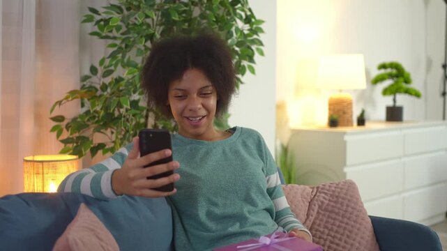 Woman celebrating a birthday online showing a gift