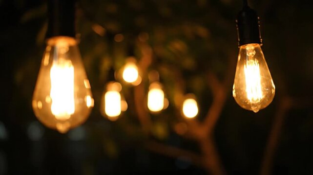 A serene evening scene with glowing light bulbs hanging from trees, viewed from a close-up perspective at dusk