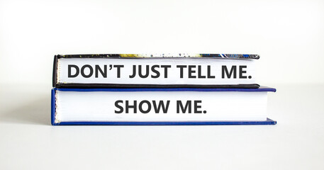 Tell or show symbol. Concept words Do not just tell me, show me on beautiful books. Beautiful white paper background. Business tell or show concept. Copy space.
