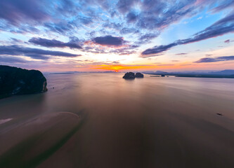 Aerial view sunset sky,Nature beautiful Light Sunset or sunrise over sea,Colorful scenery sunset Panorama Sky with Amazing clouds and waves in the ocean golden light cloud background