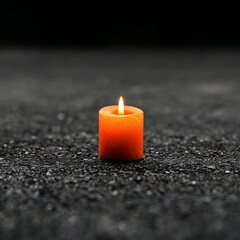 orange tiny Candle shining very small in a black Environment