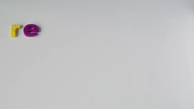 Stop motion video at 24fps of a male hand arranging and rearranging the letters R, E, A, and D until forming the word &ldquo;READ.&rdquo; The sequence highlights learning difficulties and dyslexia.