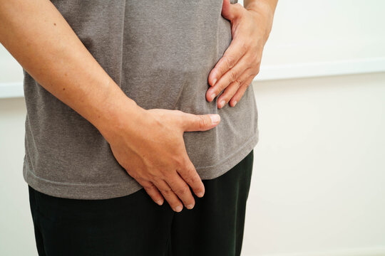 Hernia, Asian man stomach ache, abdominal pain and urology problem health.