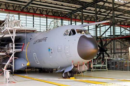 Airbus A400M transport aircraft parked inside an aircraft hangar during ground maintenance.