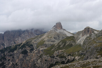 Hiking perspective from Rifugio Locatelli, close‑up of jagged peak wrapped in low clouds
