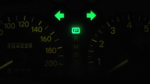 Car hazard warning lights flashing on a dashboard creating a rhythmic mechanical clicking sound