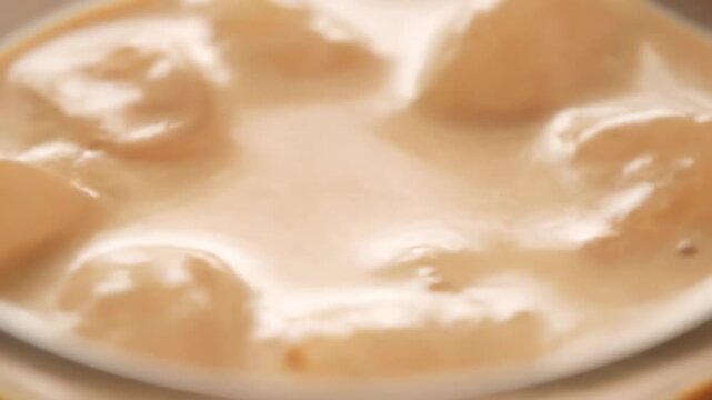 Abstract macro close-up of smooth, creamy light brown texture or sauce surface, highly blurred and defocused background ideal for food, dessert, beverage, or cosmetic product concepts.