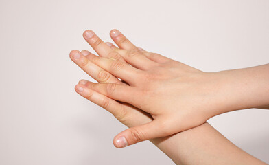 Female hand with a finger touching her finger for disinfekting hands with disinfection liquid or water and soap in hospital. 