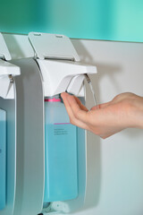 Hand disinfection with disinfectant dispensers in hospitals or doctors' offices. Disinfection - Hygiene. Influenza virus. 
