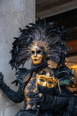 Luxurious black and gold Venetian carnival mask during Carnival in Venice, Italy