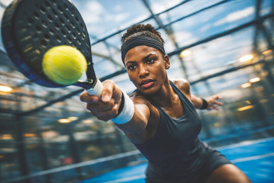 Female athlete playing padel tennis with motion blur effect