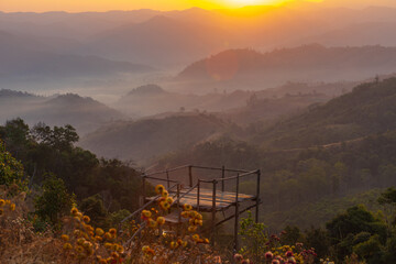 Beautiful sunrise in the morning with sea of mist on hight moutain, Mon Mok Tawan, Tak Province, Thailand.
