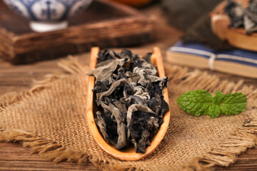 Dried Black Linden Flowers in Wooden Spoon with Fresh Mint © VuVan