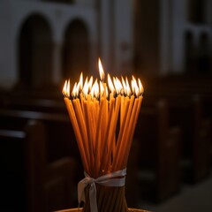 Bunch of lit candles in a dark church. Religious tradition concept. Warm light for prayer, hope, faith, and remembrance.