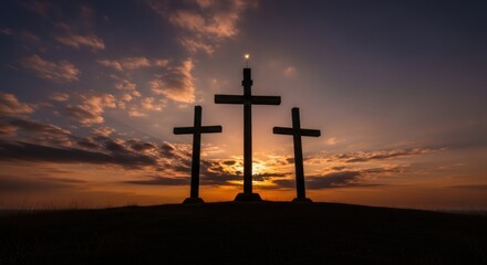 Three crosses silhouetted on a hill at sunset. Religious symbol of resurrection and sacrifice for Easter and Good Friday. Christian concept.