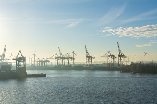 Container cranes at Hamburg harbor container terminal on the Elbe river
