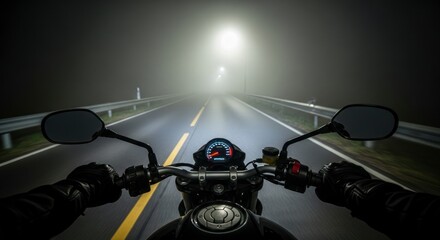 Motorcycle riding on dark highway.