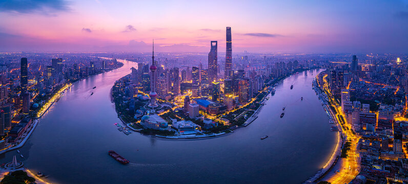 Majestic aerial view of the Shanghai skyline and Huangpu River at sunrise in China.