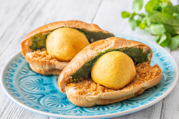 Vada Pav Indian street food served on blue plate in bright overhead composition