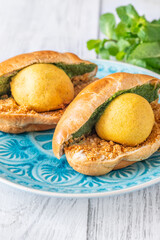 Vada Pav Indian street food served on blue plate in bright overhead composition