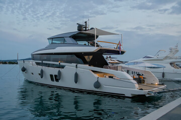 Fototapeta premium Elegant white motor yacht with sun awning on the top deck