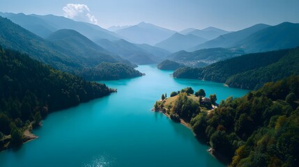 Serene Turquoise River Winding Through Lush Green Mountains Under a Hazy Sky.