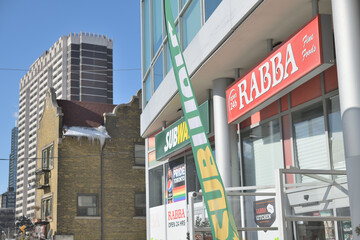 Fototapeta premium perspective view of signs outside Rabba Fine Foods and Subway Sandwich shop, 148 Wellesley St, Toronto