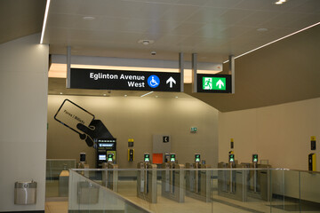Fototapeta premium interior view of an Eglinton Line 5 station featuring entry gates and Presto vending machines, Toronto