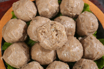 Fototapeta premium Handmade Chaoshan Beef Tendon Balls Traditional Chinese Meatballs on Green Leaves Studio Shot