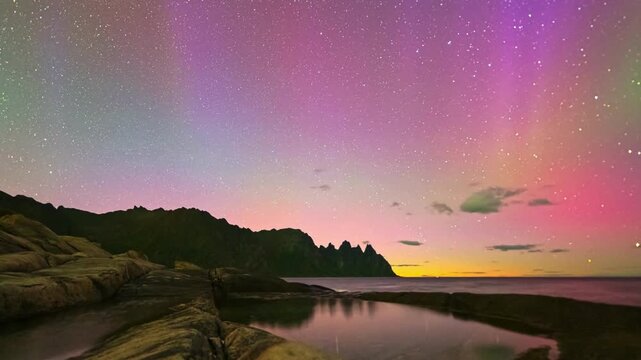 Scenic color with green and purple northern lights over a dark winter horizon. amazing events of Universe