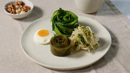 Minimalist healthy plate with egg sprouts and leafy greens