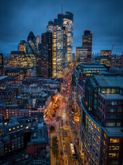 Eelevated view of the illuminated City of London skyline during dusk with Liverpool Street traffic...