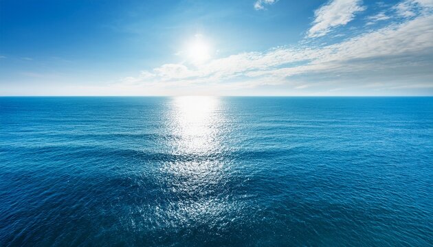 blue ocean panorama with sun reflection ripple waves and calm sea with beautiful sunlight