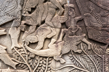 Angkor Thom, Siem Reap, Cambodia.  Detailed carvings of the Khnmer army being attacked by crocodile in the east gallery