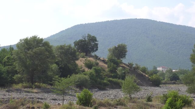 Green trees and church on the hill. Oguz, Azerbaijan.
