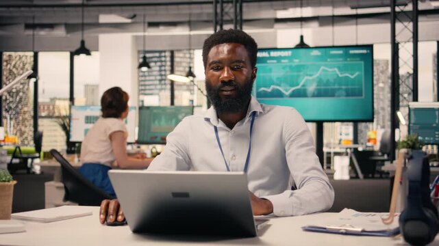 Black man worker, monetary data, performance review, laptop screen, corporate workspace, analytics dashboard, resource allocation, productivity, global business success. Business intel.