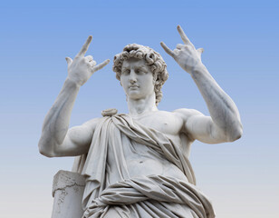 Marble statue of a figure holding hands in a devil sign pose under a blue sky in an outdoor setting