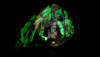 Speleology Exploration Scene in Green Lit Natural Cave