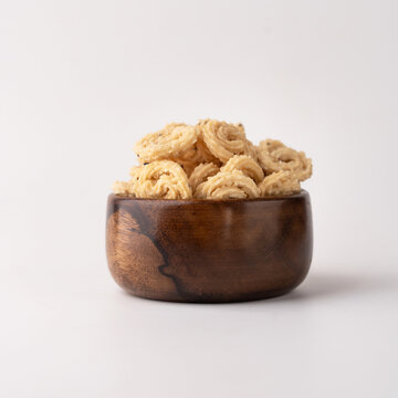 Murukku a south Indian snack on wooden background.