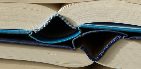 old books are laying on a table