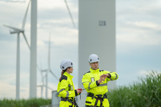 Engineers working on site in wind turbine farm, Wind turbines generate clean energy source, Eco technology for electric.