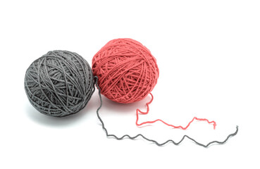 Grey and red woolen balls on a white background.