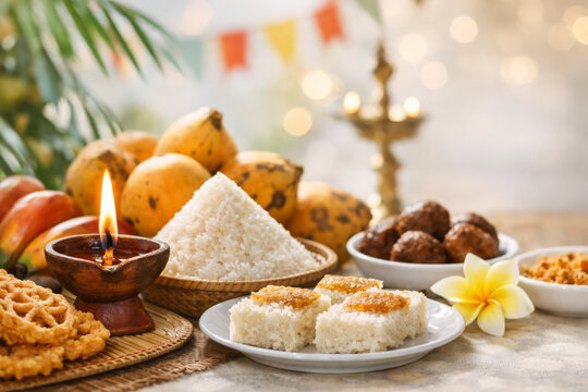 Sri Lankan New Year food table with milk rice, sweets and oil lamp for Aluth Avurudu celebration.