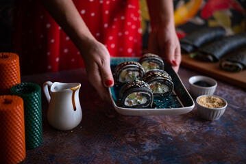 Black sushi roll made from pancakes