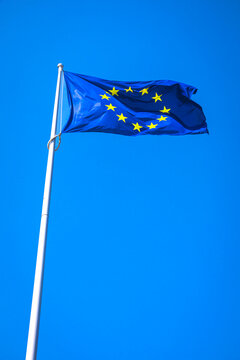 A European Union flag in a blue sky