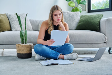 Obraz premium Serious sad young woman with business important papers in home interior